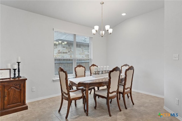 dining room with lofted ceiling and a chandelier