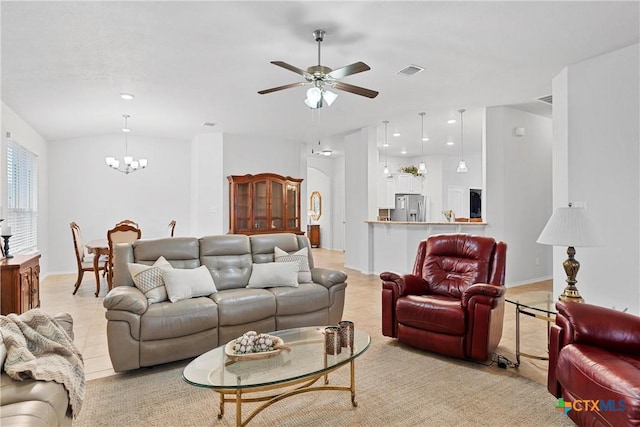 living room featuring light tile patterned floors and ceiling fan with notable chandelier