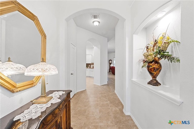 hallway featuring light tile patterned flooring