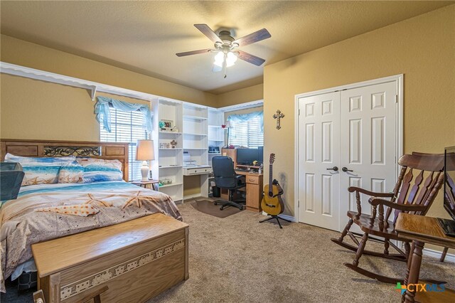 bedroom with ceiling fan, a closet, light carpet, and multiple windows