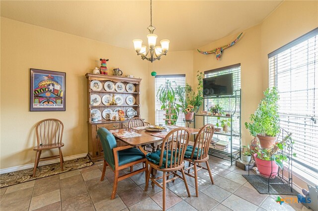 dining area featuring a wealth of natural light and an inviting chandelier