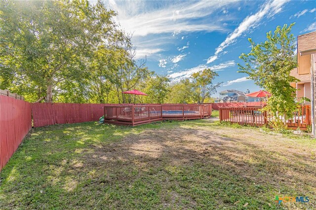 view of yard featuring a wooden deck