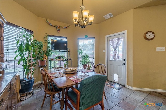 dining area featuring an inviting chandelier