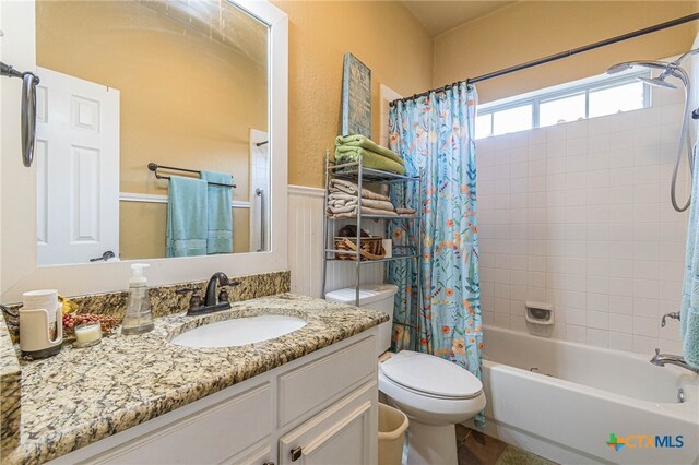 full bathroom featuring vanity, toilet, and shower / tub combo with curtain