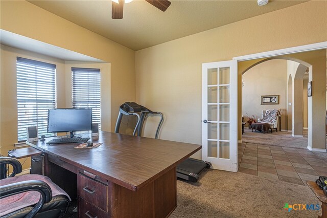 office featuring carpet flooring, ceiling fan, and french doors