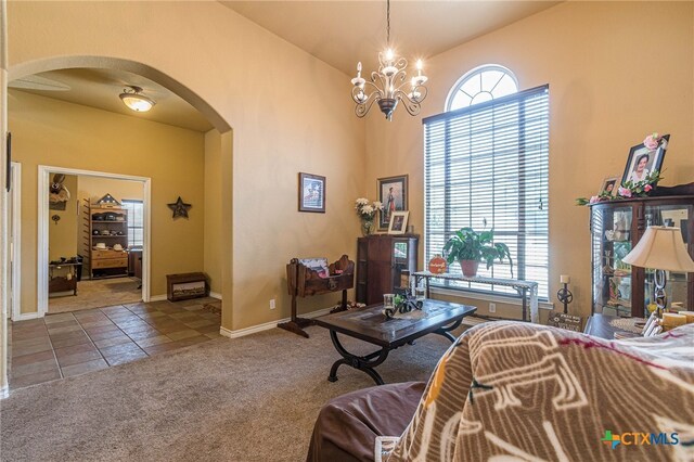 living room featuring carpet, a wealth of natural light, and a chandelier