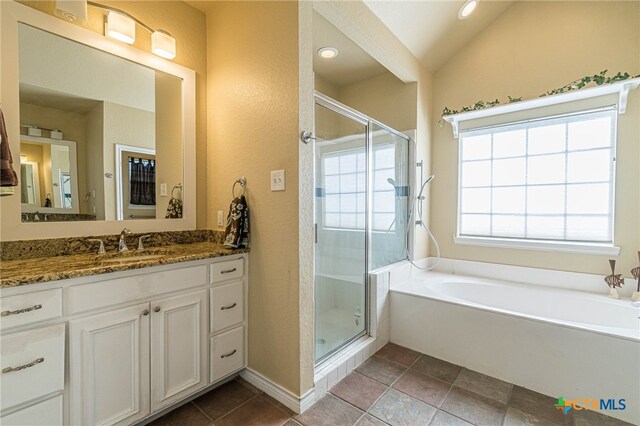 bathroom with vanity, plus walk in shower, and lofted ceiling