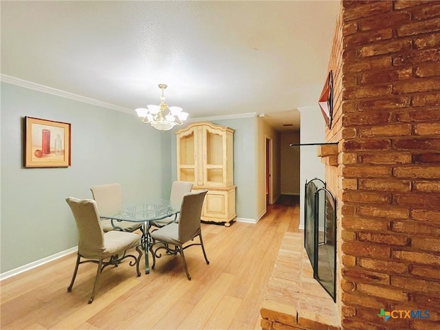 3811 River Oaks Cir, Temple, TX 76504 - dining room with crown molding, light wood-style flooring, a chandelier, and baseboards