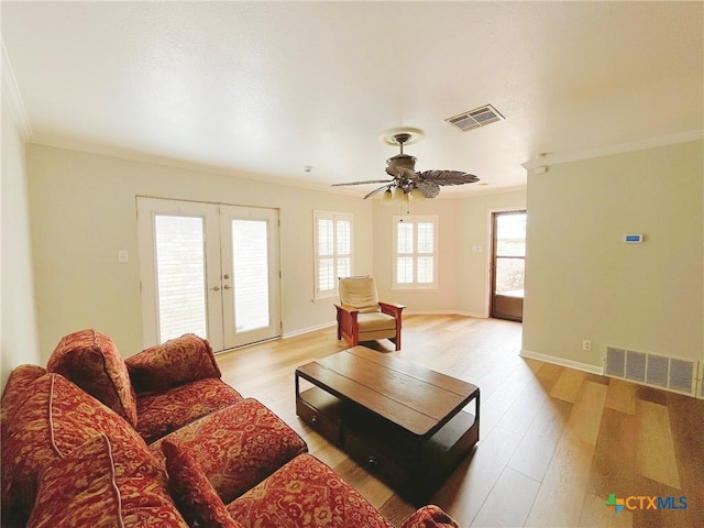 3811 River Oaks Cir, Temple, TX 76504 - living area featuring crown molding, light wood-style floors, french doors, baseboards, and a ceiling fan
