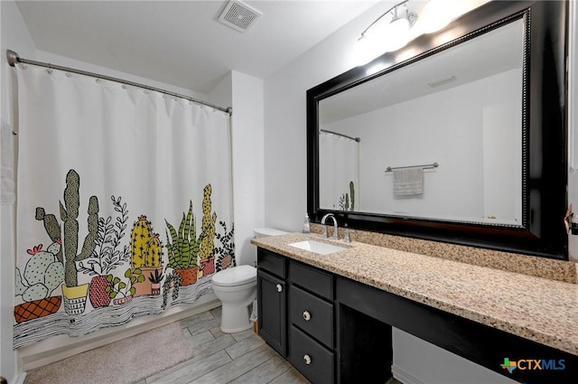 7410 Tom Watson Ct, San Antonio, TX 78244 - bathroom with toilet, vanity, wood finished floors, and a shower with shower curtain