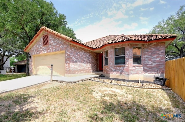 7410 Tom Watson Ct, San Antonio, TX 78244 - view of front of property with an attached garage, a tile roof, brick siding, and concrete driveway