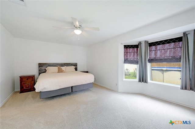 7410 Tom Watson Ct, San Antonio, TX 78244 - carpeted bedroom with baseboards and ceiling fan