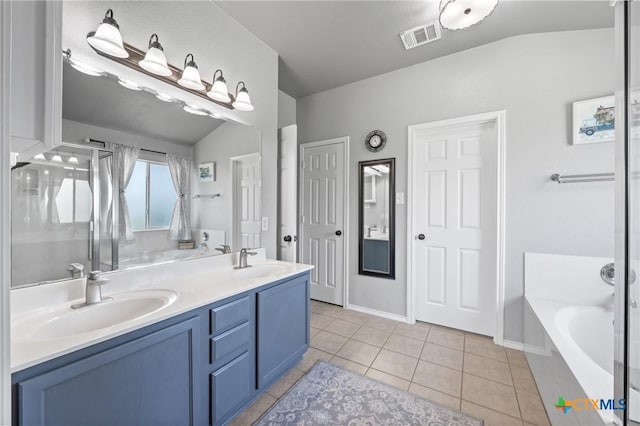 4904 Sodalite Ct, Killeen, TX 76542 - bathroom with a garden tub, double vanity, tile patterned flooring, a stall shower, and lofted ceiling