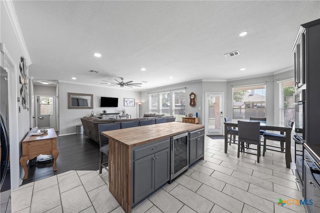 4904 Sodalite Ct, Killeen, TX 76542 - kitchen featuring wood counters, wine cooler, crown molding, recessed lighting, and open floor plan
