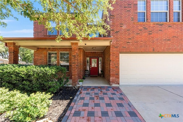 4904 Sodalite Ct, Killeen, TX 76542 - entrance to property featuring a garage, concrete driveway, and brick siding