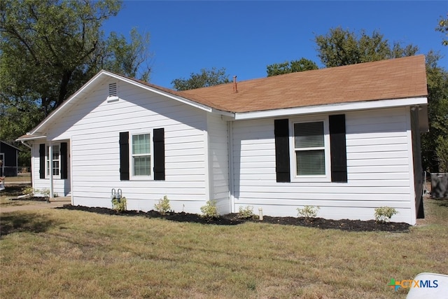 view of property exterior with a yard