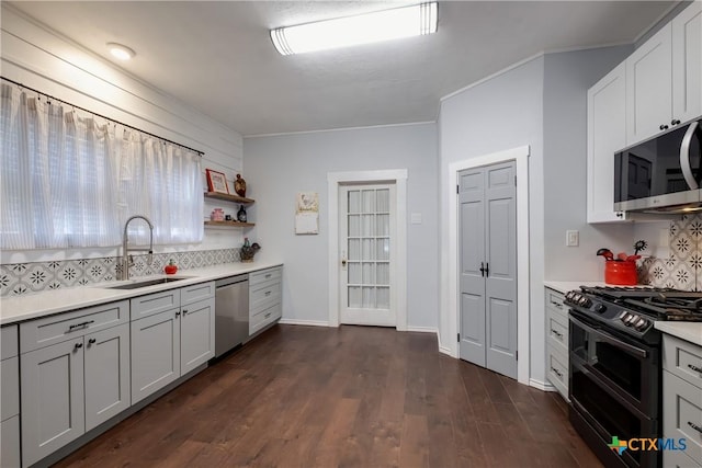 721 W Kings Hwy, San Antonio, TX 78212 - kitchen with stainless steel appliances, a sink, decorative backsplash, light countertops, and ornamental molding