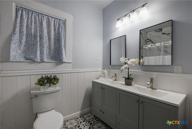 721 W Kings Hwy, San Antonio, TX 78212 - bathroom featuring wainscoting, toilet, double vanity, a shower, and tile patterned flooring