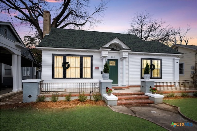 721 W Kings Hwy, San Antonio, TX 78212 - view of front of property with covered porch, roof with shingles, a chimney, and a lawn