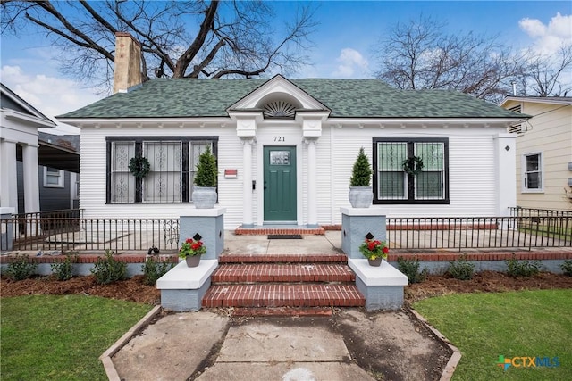 721 W Kings Hwy, San Antonio, TX 78212 - view of front of home featuring covered porch, a shingled roof, and a chimney