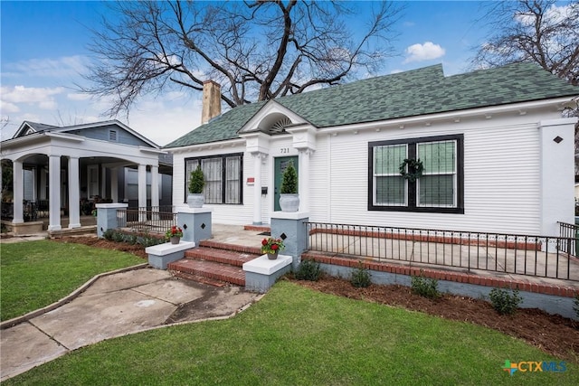 721 W Kings Hwy, San Antonio, TX 78212 - view of front of house with a front lawn, a chimney, a porch, and a shingled roof