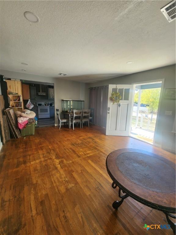 interior space featuring hardwood / wood-style floors and a textured ceiling