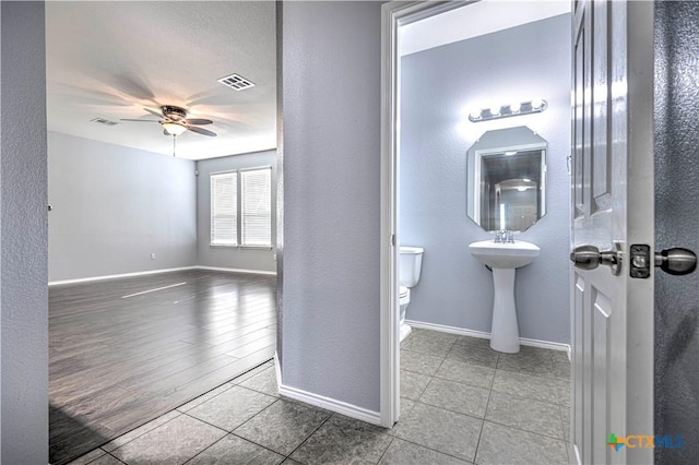 bathroom featuring tile patterned floors, toilet, and ceiling fan