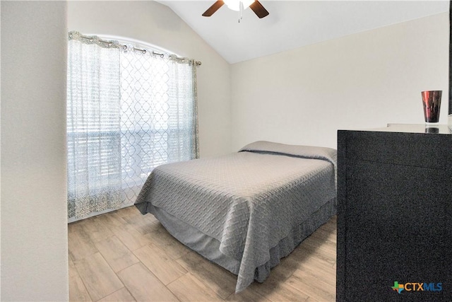 bedroom featuring vaulted ceiling, wood-type flooring, and ceiling fan