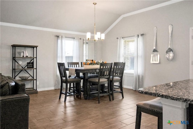 dining room featuring lofted ceiling, dark wood-type flooring, ornamental molding, and an inviting chandelier