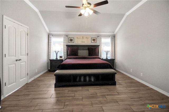 bedroom featuring crown molding, vaulted ceiling, and multiple windows