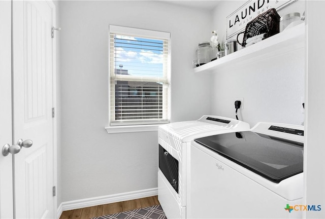 washroom featuring washing machine and clothes dryer and dark hardwood / wood-style floors