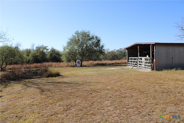 view of yard with an outbuilding and a rural view