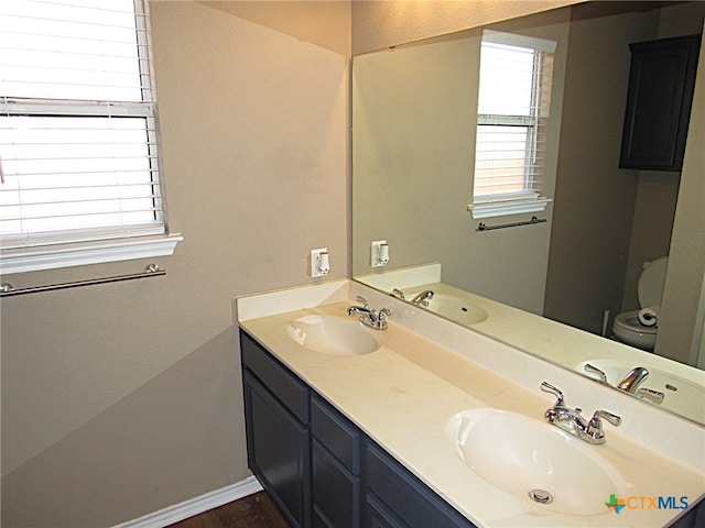 bathroom featuring vanity and toilet