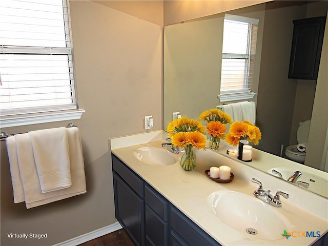 bathroom featuring vanity and toilet