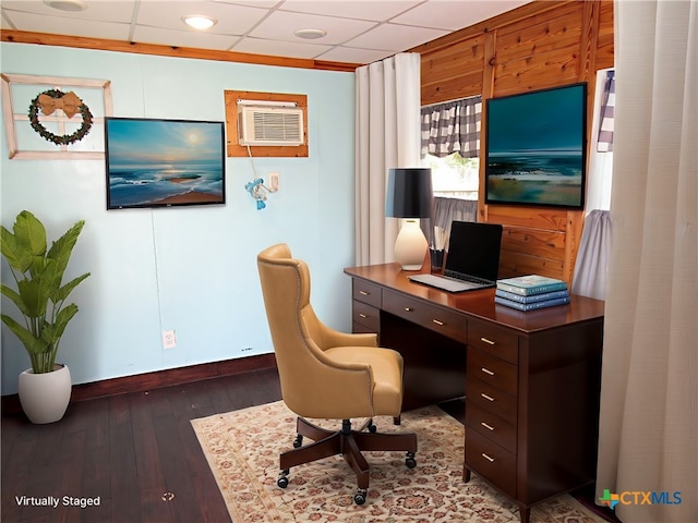 home office featuring a wall mounted AC, dark hardwood / wood-style flooring, and a drop ceiling