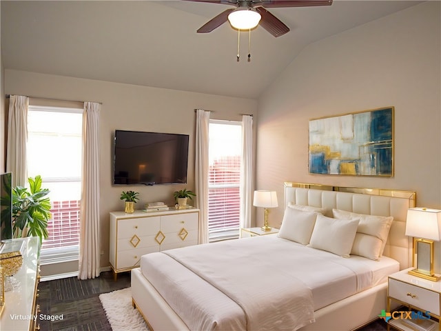 bedroom featuring ceiling fan, dark wood-type flooring, and lofted ceiling