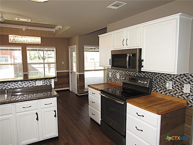 kitchen featuring tasteful backsplash, black electric range, dark hardwood / wood-style floors, white cabinets, and ornamental molding