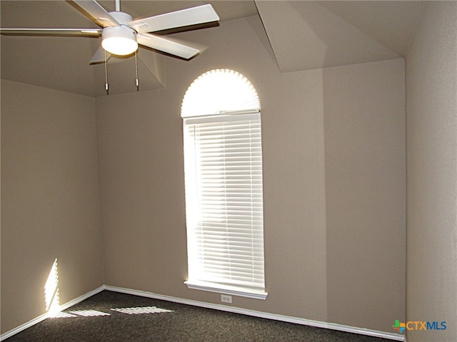 carpeted spare room with a wealth of natural light, ceiling fan, and lofted ceiling