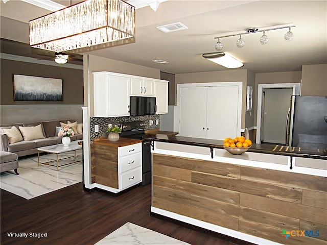 kitchen featuring backsplash, black appliances, white cabinets, butcher block countertops, and dark hardwood / wood-style flooring