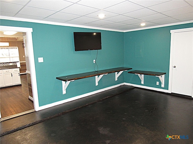 interior space with crown molding and a drop ceiling