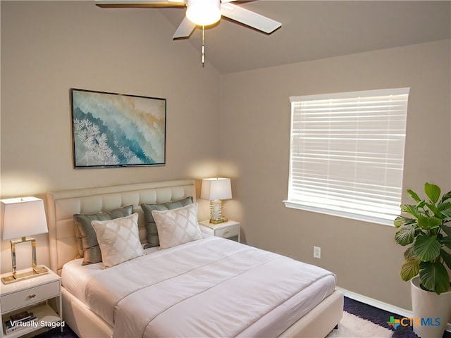 bedroom featuring ceiling fan and lofted ceiling