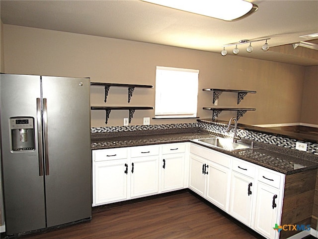 kitchen with dark stone counters, white cabinets, sink, dark hardwood / wood-style floors, and stainless steel fridge with ice dispenser