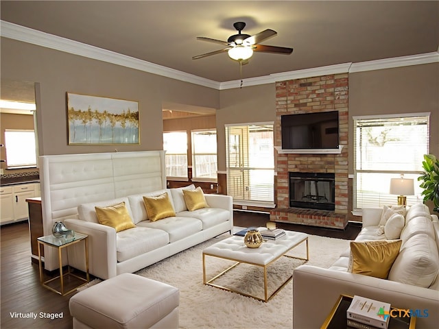 living room with a healthy amount of sunlight, dark hardwood / wood-style flooring, and crown molding