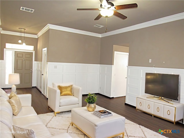 living room featuring dark hardwood / wood-style flooring, ceiling fan, and ornamental molding