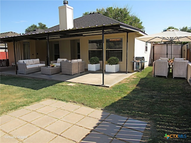 back of property featuring a yard, an outdoor living space, and a patio area