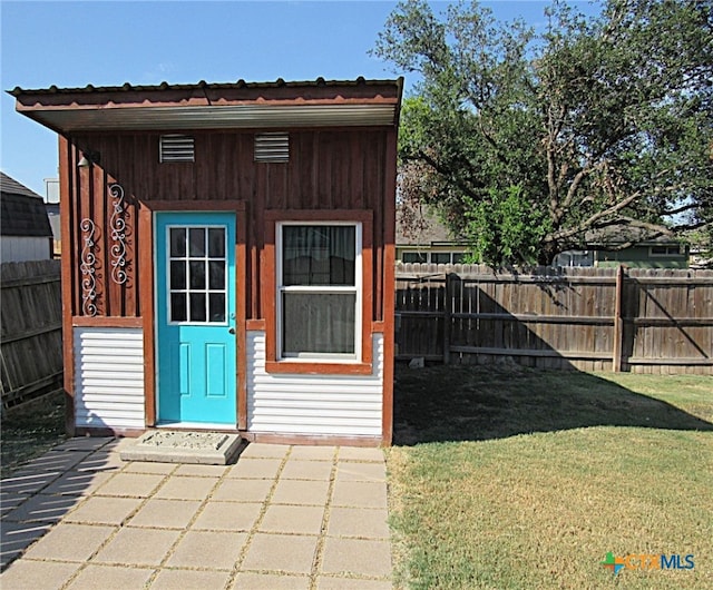 view of outdoor structure featuring a lawn