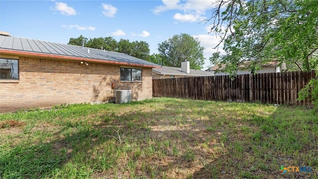 view of yard featuring cooling unit and fence