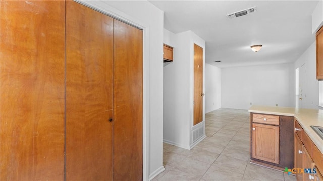 corridor with light tile patterned floors and visible vents