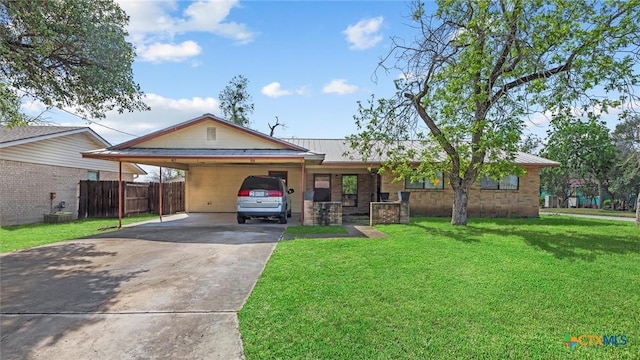 ranch-style house featuring a front yard, metal roof, driveway, a carport, and fence