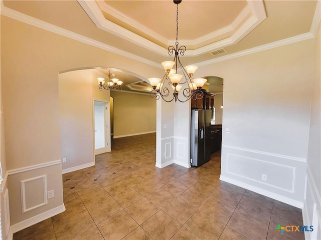 6409 Jovana Dr, Killeen, TX 76542 - tiled empty room featuring arched walkways, a chandelier, a raised ceiling, crown molding, and a decorative wall